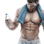 Strong Athletic Man Fitness Model Torso showing six pack abs. holding bottle of water and towel