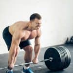 Handsome weightlifter preparing for training. Shallow depth of field